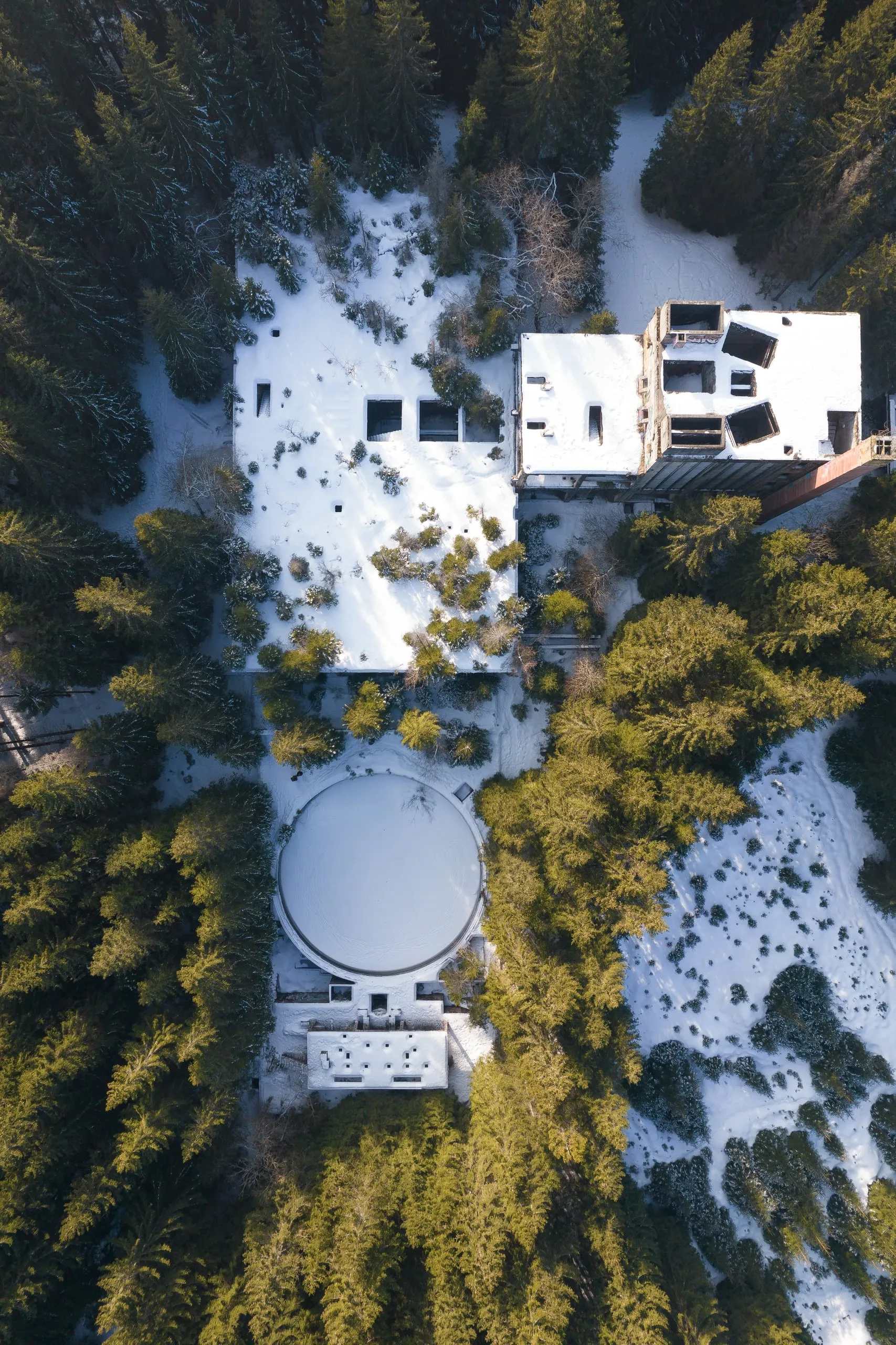 Concrete ruins in the forest at Sauersack with patches of snow, from straight above