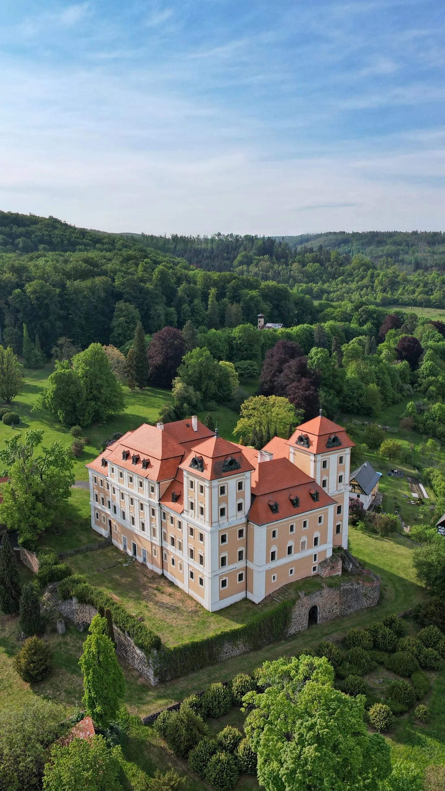 Valeč State Château with red roofs in the middle of its park