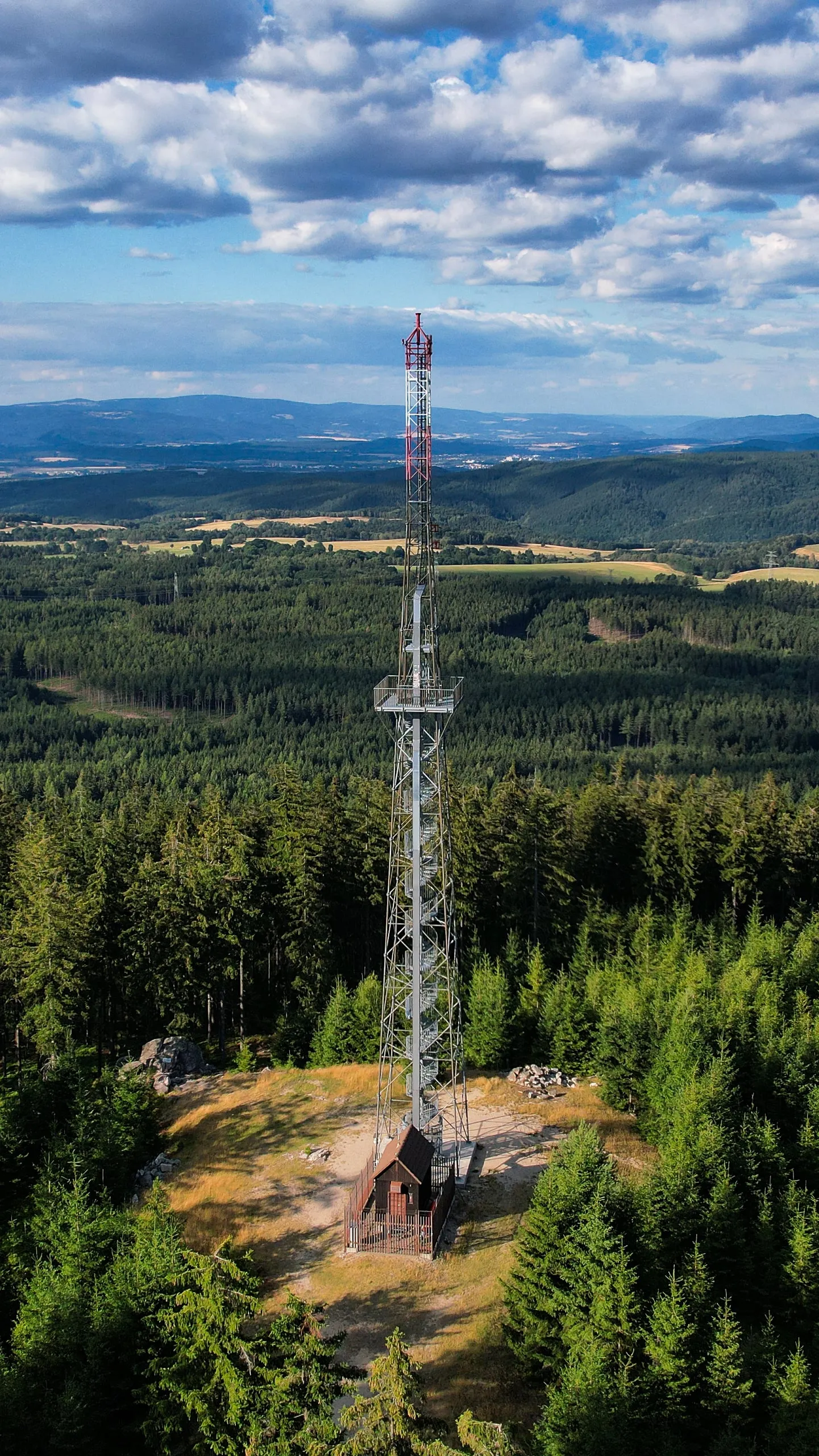 The Krudum lookout tower, a lattice mast on a rock above the forests